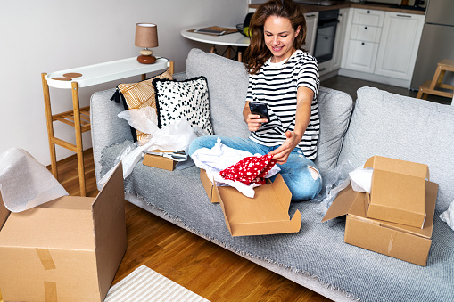 a woman sitting in a room with many Shipping Boxes